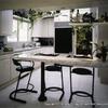 Bold contrasts between tan and black update this kitchen.  No space is wasted here…a narrow pull out spice rack sits between the built in refrigerator and the lazy suzan.