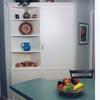 L-shaped walls were removed from this former pantry area to make room for the island, but its storage was more than replaced just this pantry and display area.  Shallow triangular shelves allow easy access to stored items.  